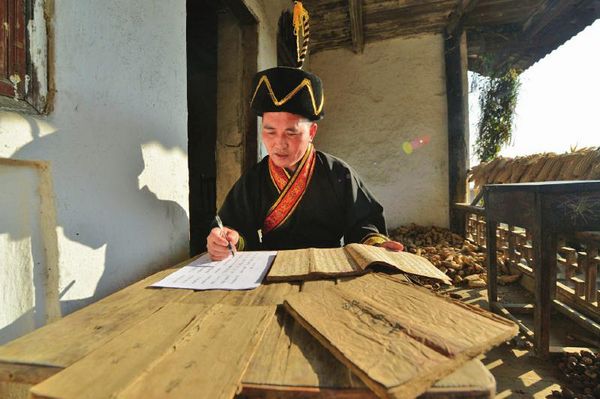 李禄清认读古彝文毕摩经书。李欣 摄